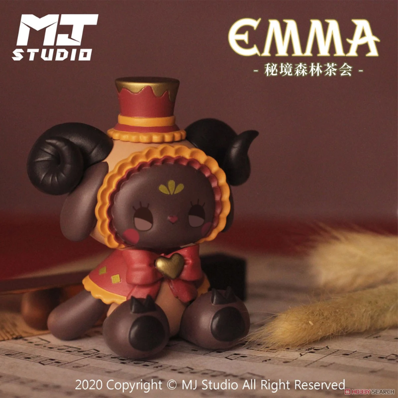 Toy figure with a hat and red dress on a textured surface, with 'MJ Studio' and 'EMMA' branding.