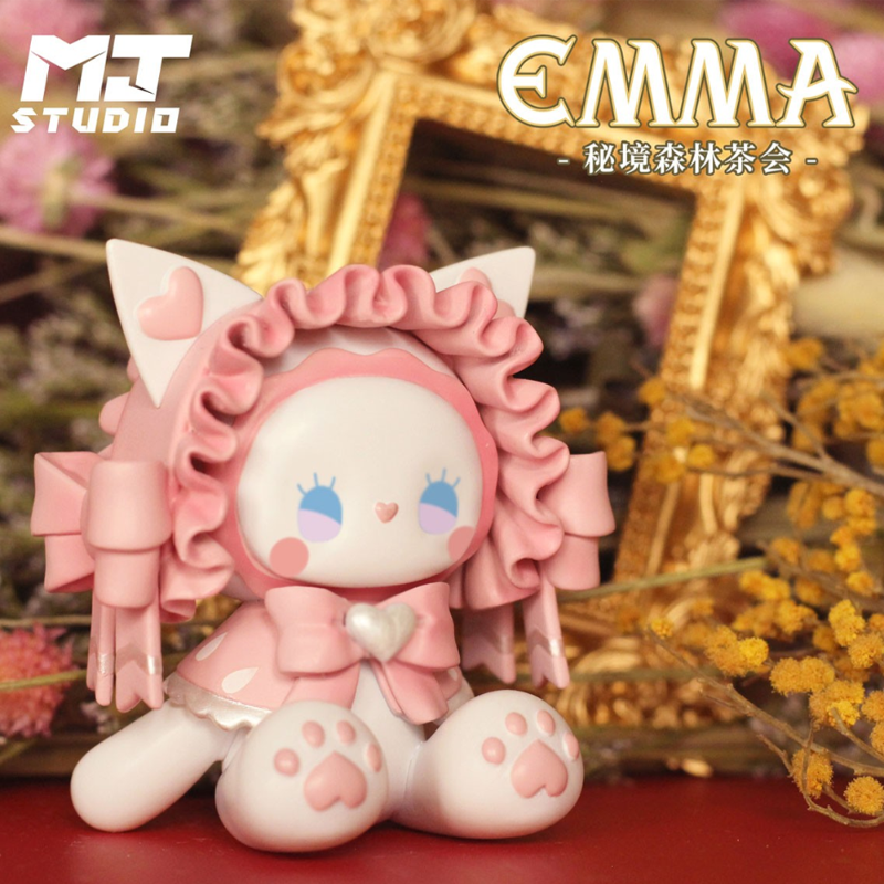 Pink cat-themed figurine with decorative elements on a blurred background