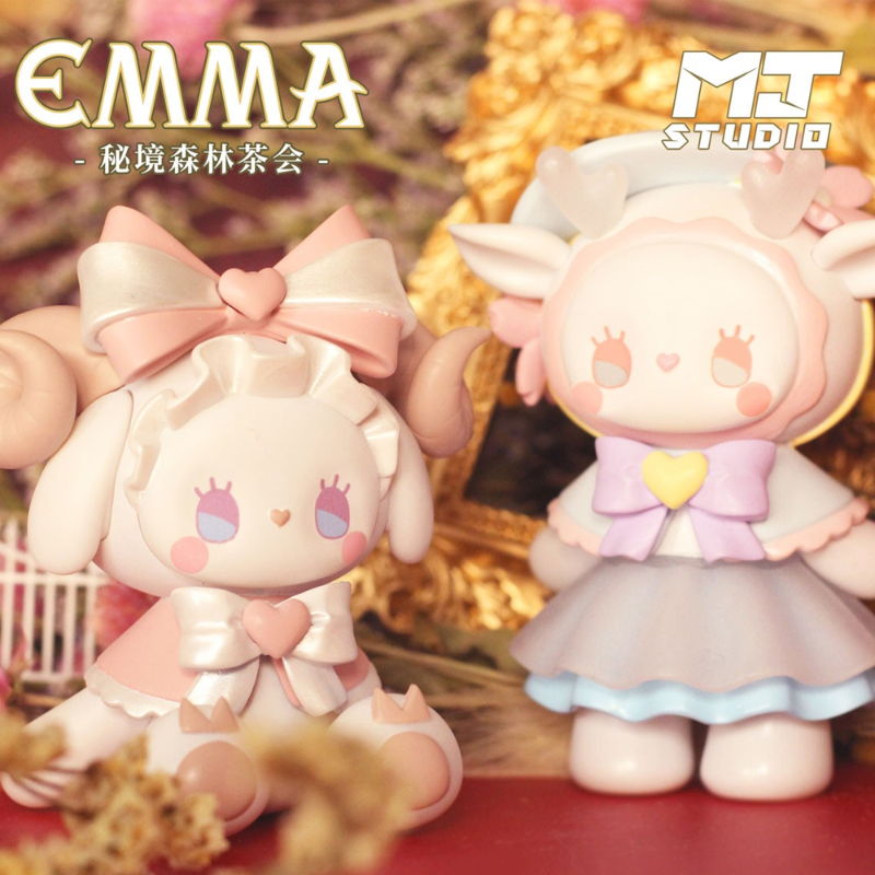 Two cute figurines with large bows, one held by a hand, on a decorative background with 'EMMA' and 'MT Studio' branding.
