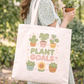 Tote bag with kawaii plant-themed design held by a person in an outdoor setting