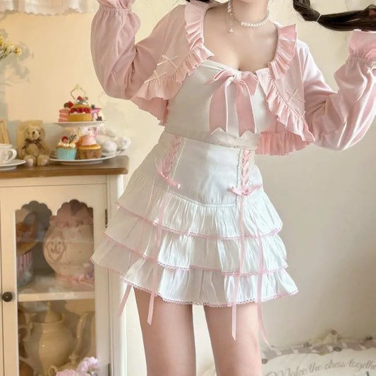 Person wearing a white dress with pink accents in a room with decorative items.