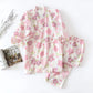 Floral pajama set on a white surface with a magazine and decorative elements.