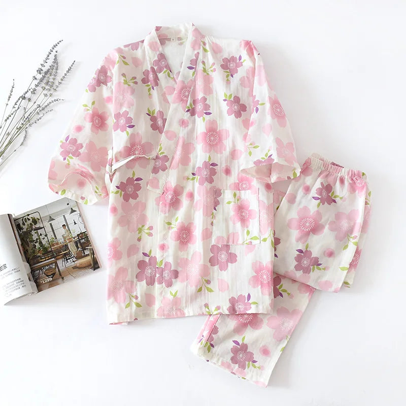 Floral pajama set on a white surface with a magazine and decorative elements.