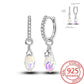 Silver earrings with teardrop-shaped crystals on a white background, featuring a 'Real Sterling 925' stamp.