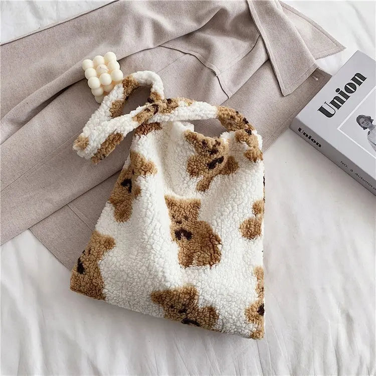 Fluffy tote bag with cute teddy bear pattern on a bed