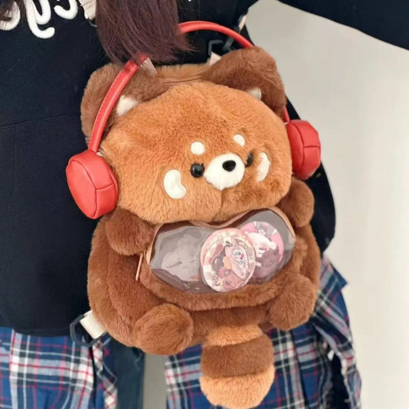 Plush red panda backpack with red headphones worn by a person
