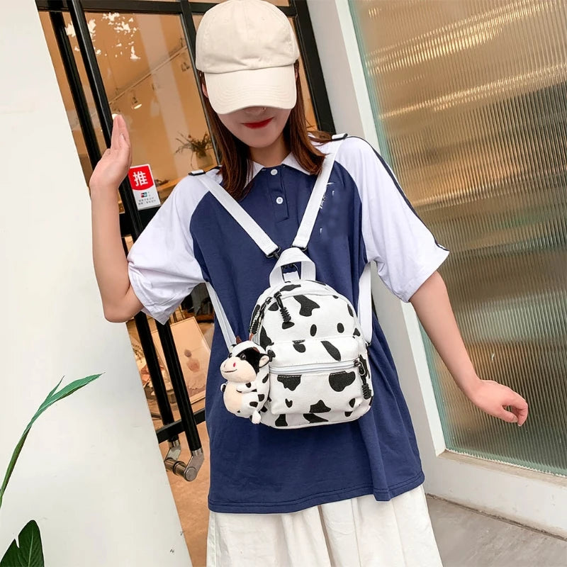 cow print mini backpack Mini Canvas Daypack With Plush Cow Pendant Cow Print Backpack Adorable Backpack For Women Lady Girls Outdoor Travel Shopping (white)(1pcs)
