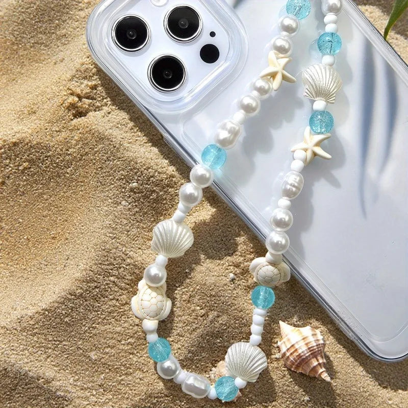 Mermaid treasure phone charm bracelet displayed on sandy beach