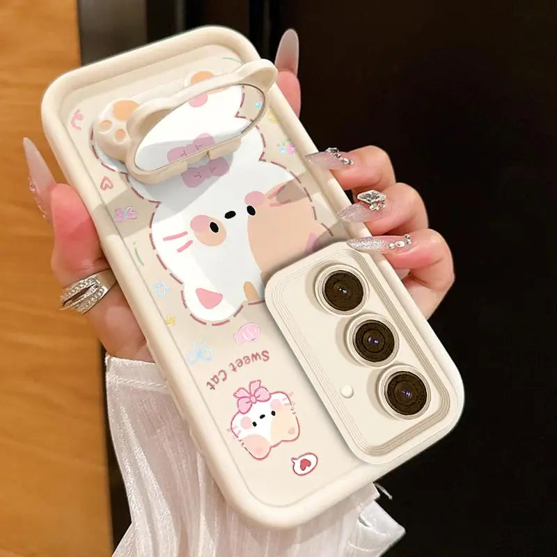 A woman is holding the Kawaii Cuties Samsung Phone Case, showing a closer view of the design of the case which features a sweet cat and a bear as a phone stand, which also includes the mirror when you position its head a certain way.