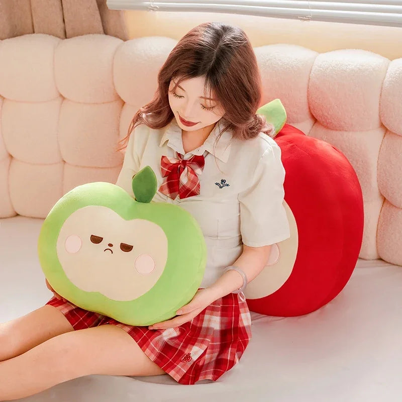 Person holding a green plush apple with a unimpressed face on a couch