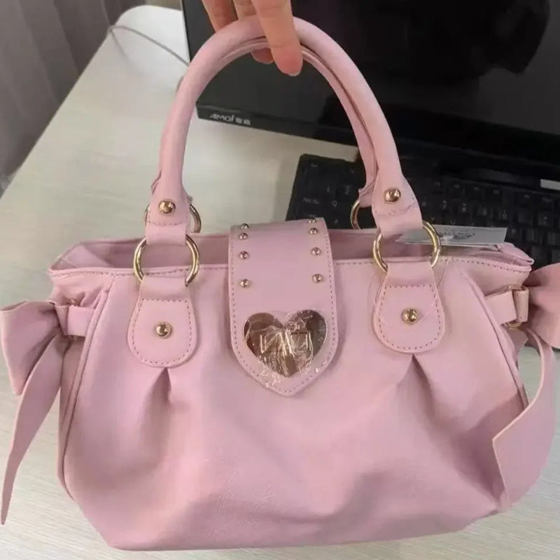 Kawaii Sweet Heart Lock Bag Pink held by a woman on a desk 