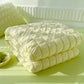 Green seersucker duvet set displayed on bed folded