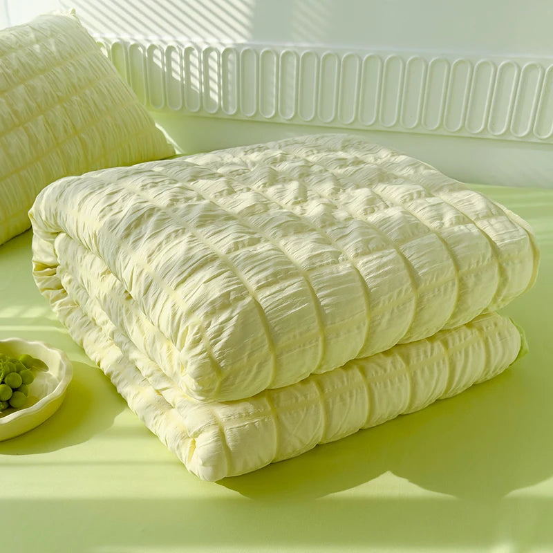 Green seersucker duvet set displayed on bed folded