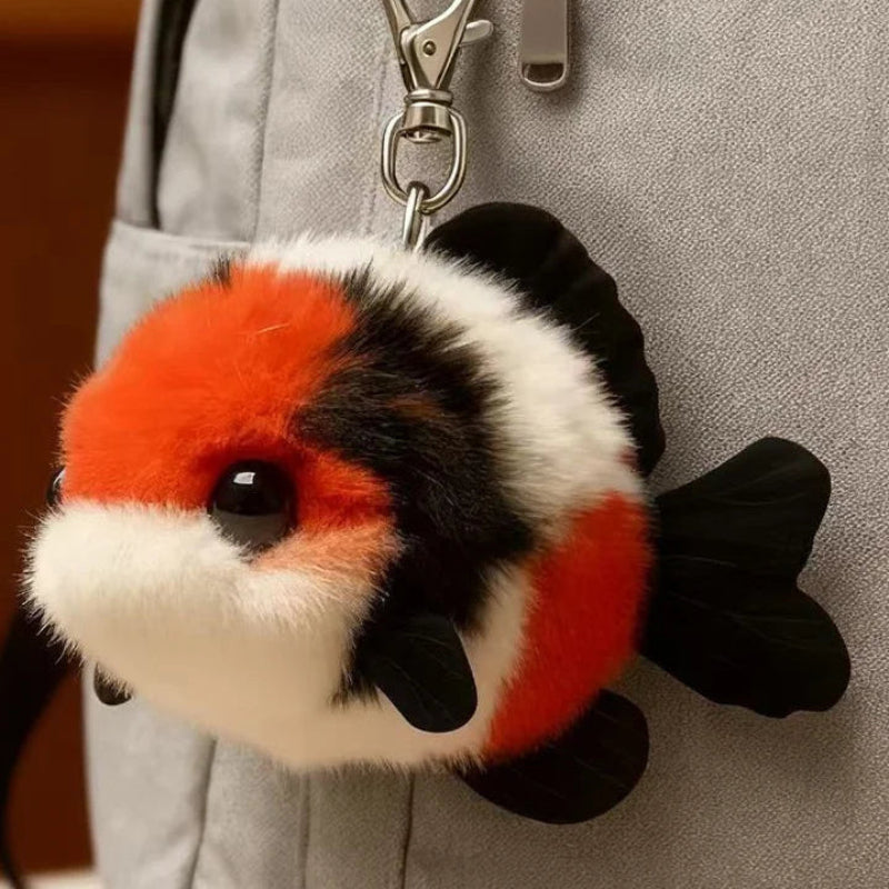 Plush fish-shaped keychain attached to a gray bag