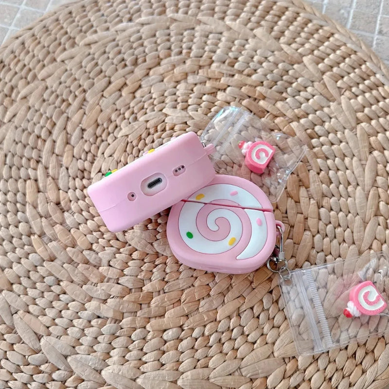 Pink swiss roll shaped air pod case  on woven place mat.
