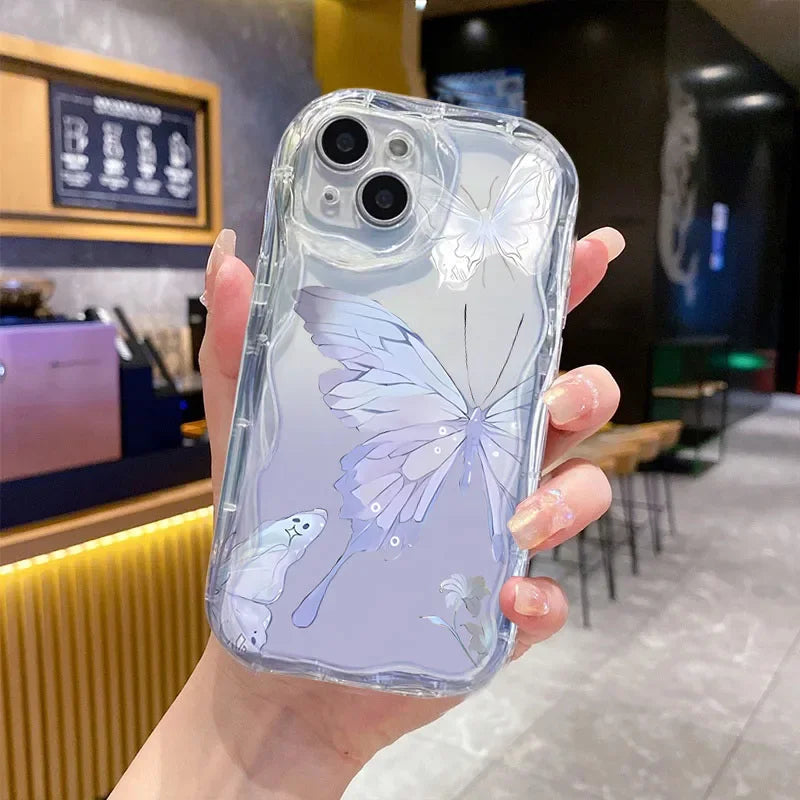 Clear phone case with butterfly design held in a hand in a cafe setting, this case design has subtle hints of blue.