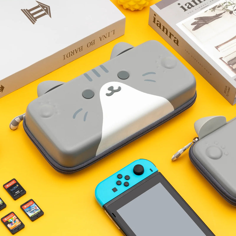 Gray cat-shaped case for a handheld gaming device on a yellow background 