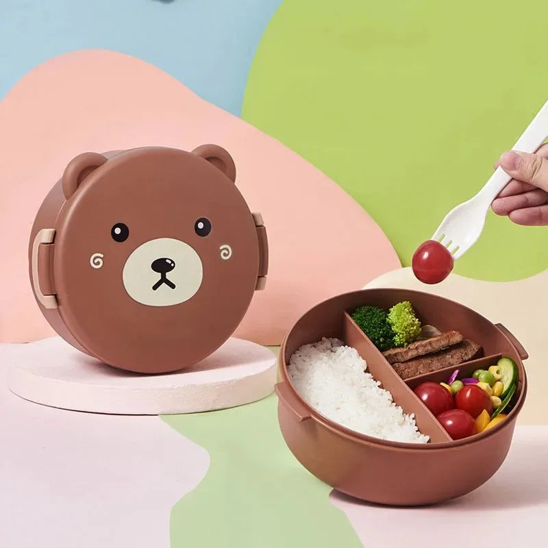 Bear-shaped bento box with food compartments on a colorful background