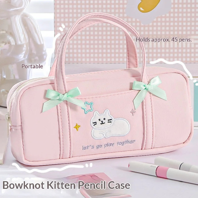 Pink pencil case with bowknot and cat design on a white background