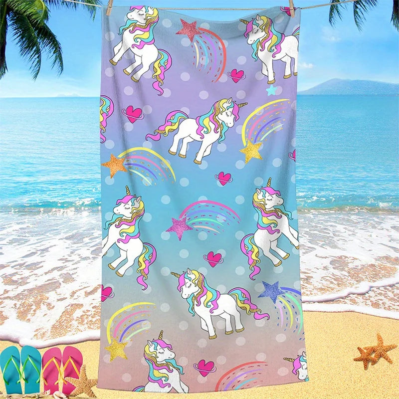 Unicorn-themed towel with colorful patterns on a beach background