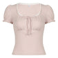Pink blouse with lace trim on a white background