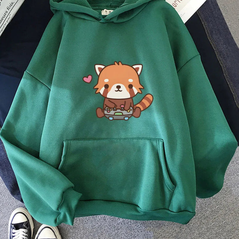 Green hoodie with a red panda design on a gray surface