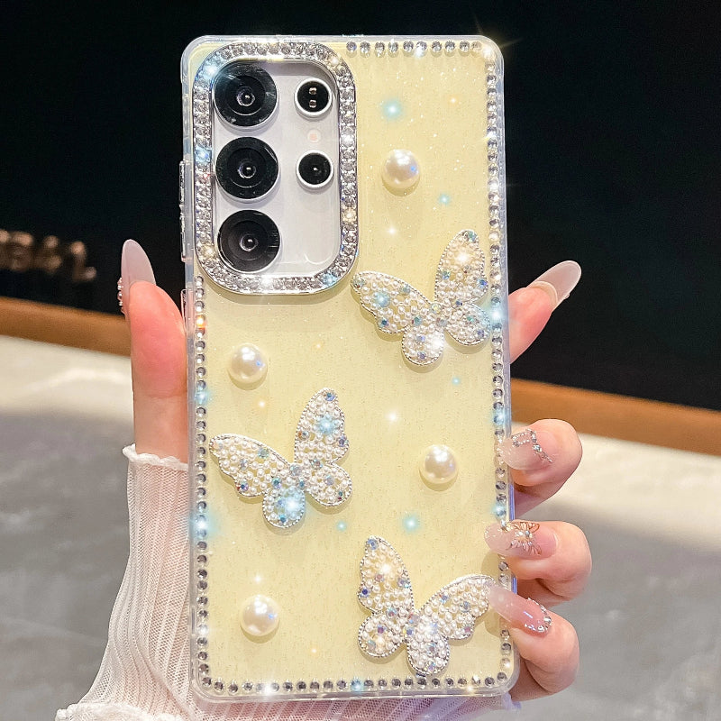 Phone case with butterfly and pearl designs held by a hand, case is pastel yellow