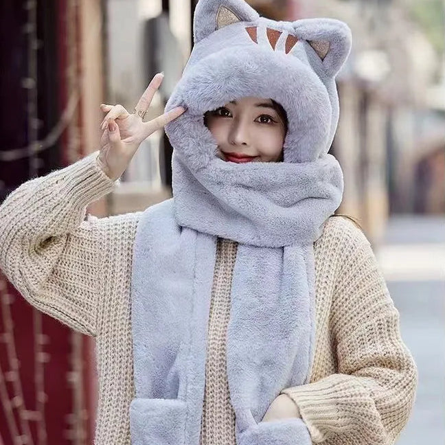 Person wearing a grey scarf and kawaii hat with cat ears in an outdoor setting