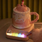 Pink Kawaii Panda Piano Cup Heater with woman using the instruments to activate it 