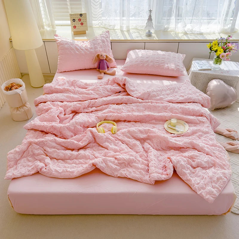 Pink seersucker duvet set displayed on bed.