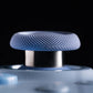 Close-up of a blue textured object with a metallic center on a black background