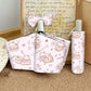 cat themed pouch and bottle holder with cute illustrations on a textured surface.