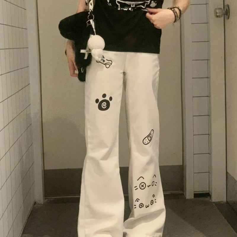 Person wearing white pants with black designs in a bathroom setting