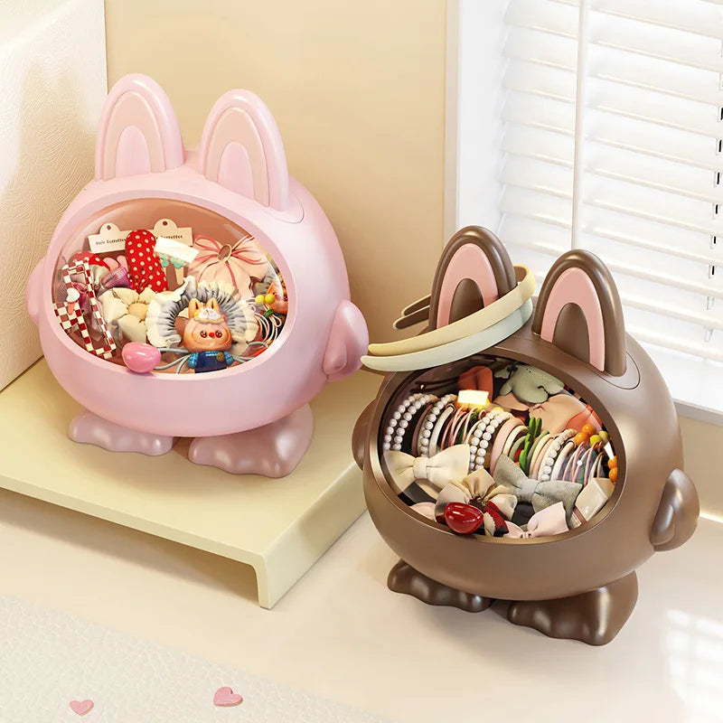 Two decorative boxes shaped like animals with colorful interior contents on a light surface.