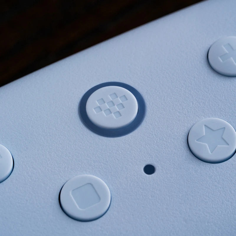 Close-up of a textured blue surface with circular buttons featuring symbols.