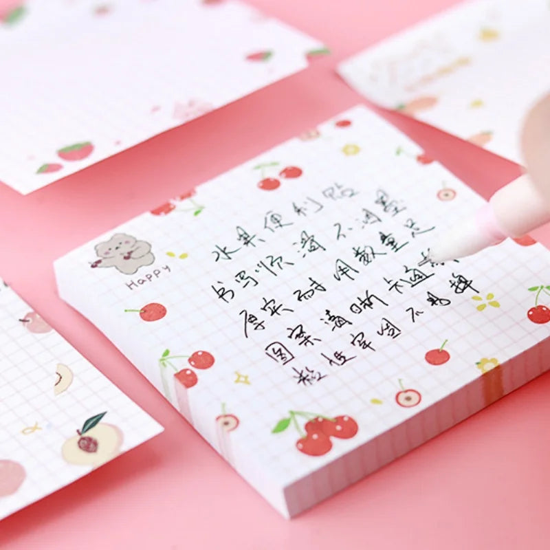 kawaii sticky note pad with cherry  illustrations on a pink background