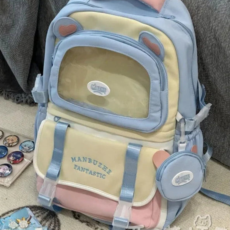 beary cute backpack with bear ears and a visible brand logo on a textured surface, blue version