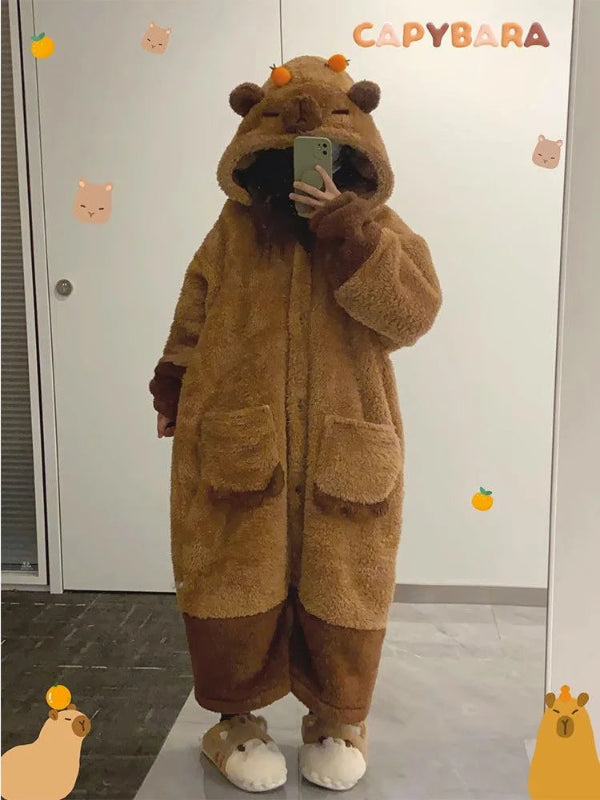 Person wearing a brown capybara onesie taking a mirror selfie.