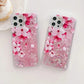 Two phone cases with pink cherry blossom design on a white background