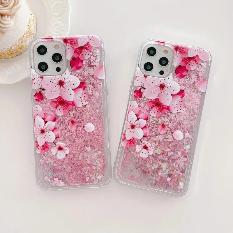 Two phone cases with pink cherry blossom design on a white background