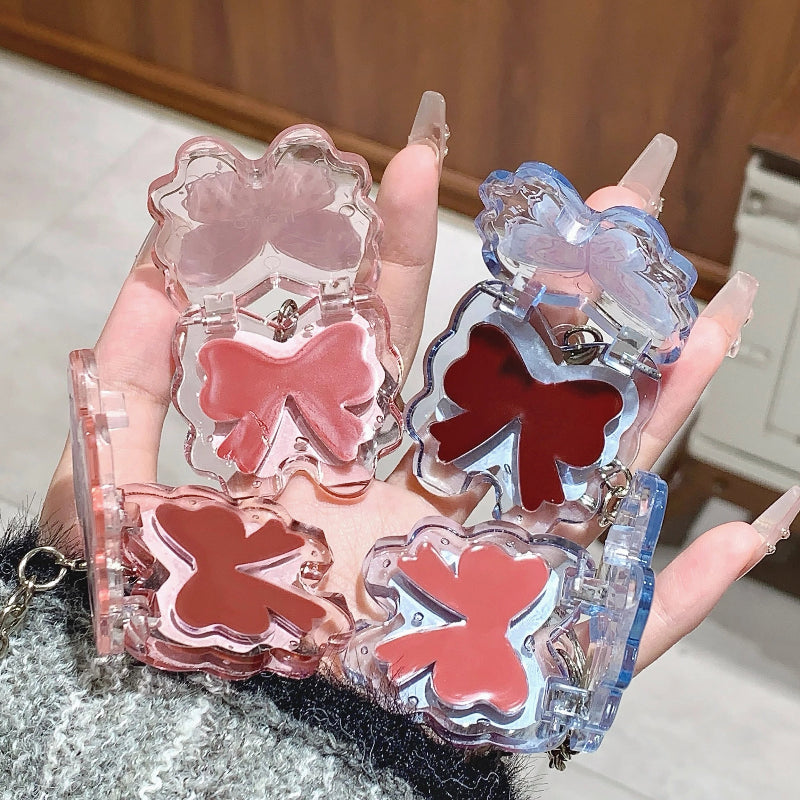 women holding kawaii butterfly lip gloss keychains with different lip shades