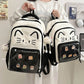 Black neko backpack displayed by person holding them.