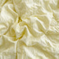 Green seersucker duvet set displayed on bed, close up image of material