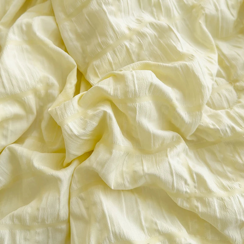Green seersucker duvet set displayed on bed, close up image of material