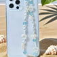 Mermaid treasure kawaii phone charm bracelet displayed on sandy beach