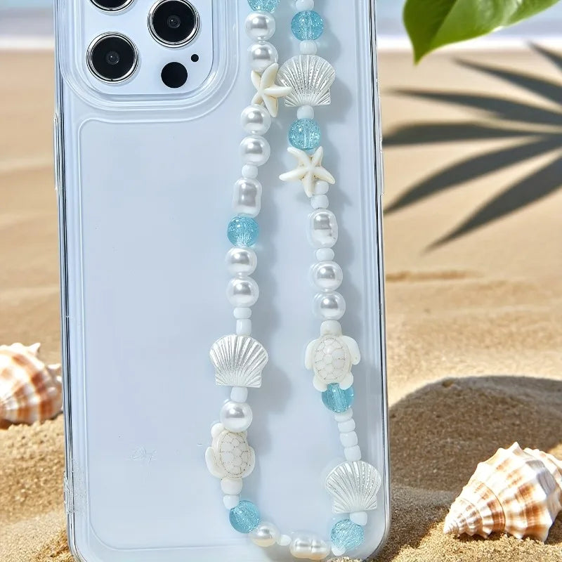Mermaid treasure kawaii phone charm bracelet displayed on sandy beach