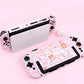 Pink gaming console with cartoon character design on a pink background