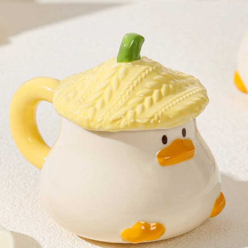 Kawaii Duck Mug with yellow Lid on countertop