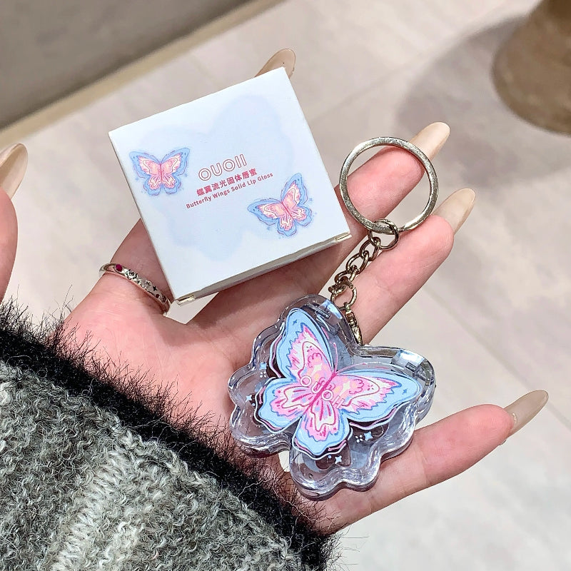women holding kawaii blue butterfly lip gloss keychain with case