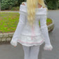 Rear view of a Kawaii Coquette Off Shoulder Ribbon Sweater modeled by a woman in white 